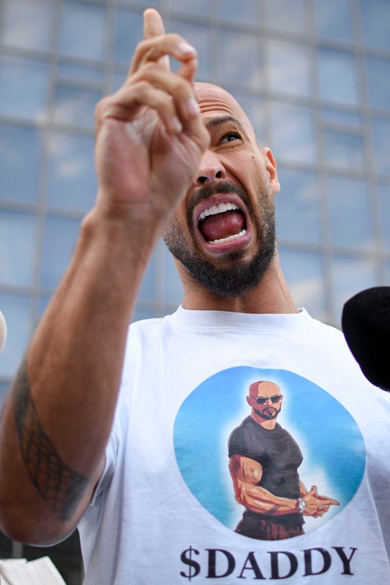 Andrew Tate speaks to media outside the Bucharest Tribunal after being placed under house arrest, in Bucharest, Romania, Thursday, Aug. 22, 2024. A court in Romania's capital on Thursday placed the divisive internet influencer Andrew Tate under house arrest for 30 days, as prosecutors investigate a sprawling new case that involves allegations of human trafficking of minors and sex with a minor. (AP Photo/Alexandru Dobre)