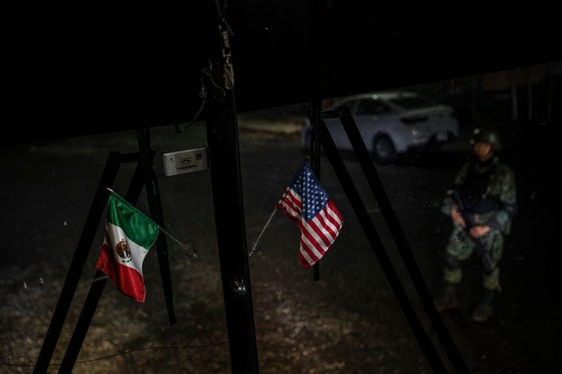 Mexican and U.S. flags decorate the window of a passenger bus that serves southern Mexico that stopped at an immigration checkpoint for inspection in Nuevo Teapa, southern Mexico, Saturday, June 8, 2024. Mexico is under pressure from the U.S. to block millions of migrants headed north. (AP Photo/Felix Marquez)