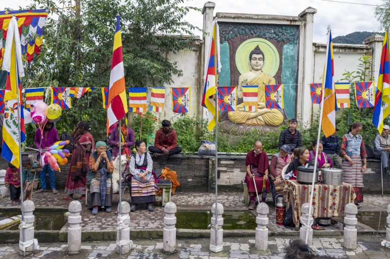 Exiled Tibetans wait to welcome their spiritual leader the Dalai Lama before he arrived in Dharamshala, India, Wednesday, Aug. 28, 2024. (AP Photo/Ashwini Bhatia)