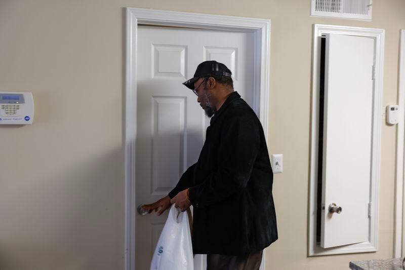 Thomas Lecky enters the bedroom in his Decatur apartment on Wednesday, May 31, 2023. Lecky moved into his apartment a month ago. (Natrice Miller/natrice.miller@ajc.com)