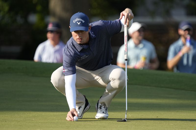 Max Greyserman lines up a putt on the ninth hole during the final round of the Wyndham Championship golf tournament in Greensboro, N.C., Sunday, Aug. 11, 2024. (AP Photo/Chuck Burton)