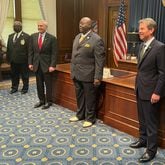 Rev. Abraham Mosley, center, poses for a photo after being sworn in as the new board chair for the Stone Mountain Memorial Association. Georgia Gov. Brian Kemp, right, and memorial association CEO Bill Stephens, left, were also present. GREG BLUESTEIN / GREG.BLUESTEIN@AJC.COM