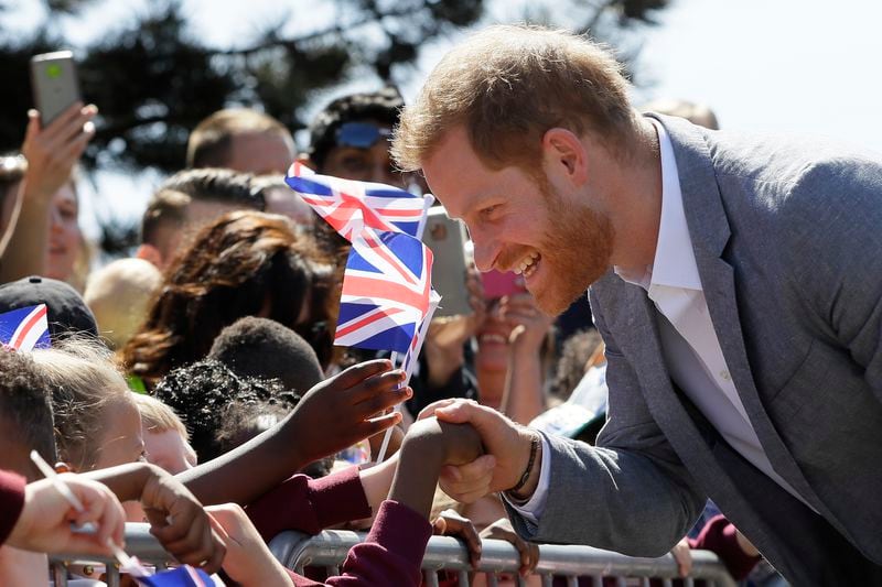 FILE - Britain's Prince Harry, The Duke of Sussex meets members of the public as he arrives for a visit to Barton Neighbourhood Centre in Oxford, England Tuesday, May 14, 2019. The centre is a hub for local residents which houses a doctor's surgery, food bank, cafe and youth club. (AP Photo/Kirsty Wigglesworth, Pool, File)