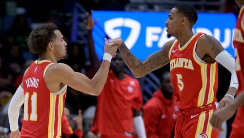 Atlanta Hawks guard Trae Young (11) celebrates a score by guard Dejounte Murray (5) during the second half of an NBA basketball game against the New Orleans Pelicans in New Orleans, Saturday, Nov. 4, 2023. (AP Photo/Matthew Hinton)
