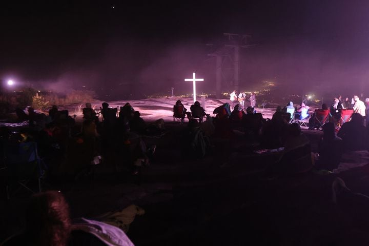 People crowd around the cross at the top of Stone Mountain before the 76th annual Easter Sunrise Service on Sunday, April 17, 2022. Miguel Martinez/miguel.martinezjimenez@ajc.com