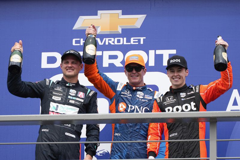 From left to right, Marcus Ericsson, second-place finisher; Scott Dixon, winner; and Marcus Armstrong, third-place finisher, celebrate after the IndyCar Detroit Grand Prix auto race in Detroit, Sunday, June 2, 2024. (AP Photo/Paul Sancya)