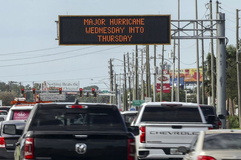 Highway signage announces the impending arrival of Hurricane Milton and the evacuations zones on Tuesday, Oct. 8, 2024, in Port Richey, Fla. (AP Photo/Mike Carlson)