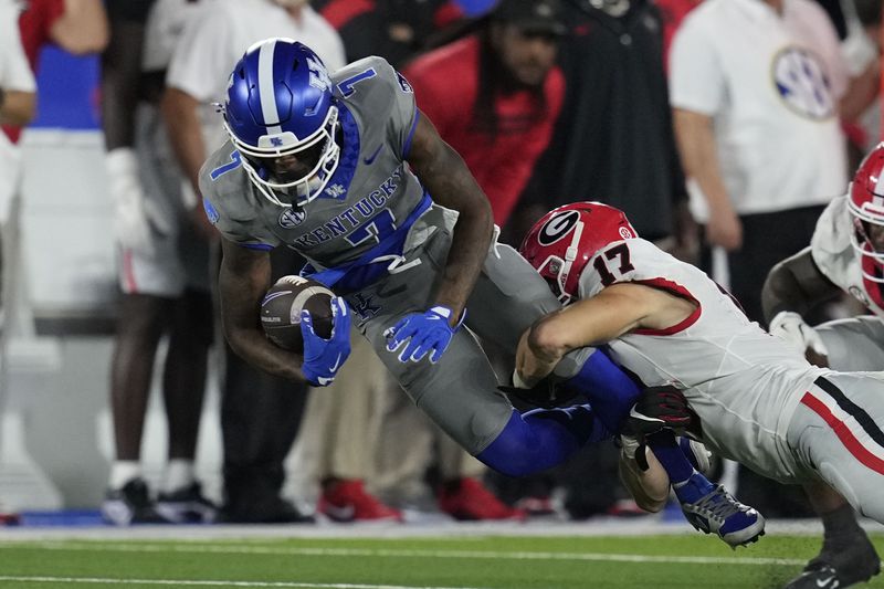 Kentucky wide receiver Barion Brown (7) is tackled by Georgia defensive back Dan Jackson (17) during the second half of an NCAA college football game, Saturday, Sept. 14, 2024, in Lexington, Ky. (AP Photo/Darron Cummings)