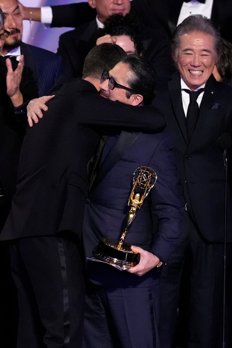 Justin Marks, left, and Hiroyuki Sanada embrace as they accept the award for outstanding drama series for "Shogun" during the 76th Primetime Emmy Awards on Sunday, Sept. 15, 2024, at the Peacock Theater in Los Angeles. (AP Photo/Chris Pizzello)