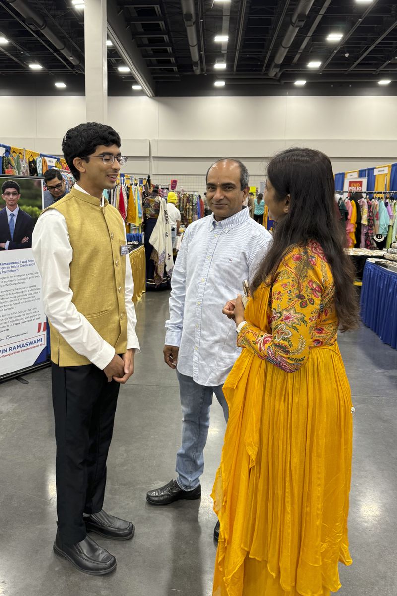 Democratic candidate Ashwin Ramaswami talks to people at the Festival of India in Duluth, Ga., on Aug. 17, 2024. (AP Photo/Charlotte Kramon)