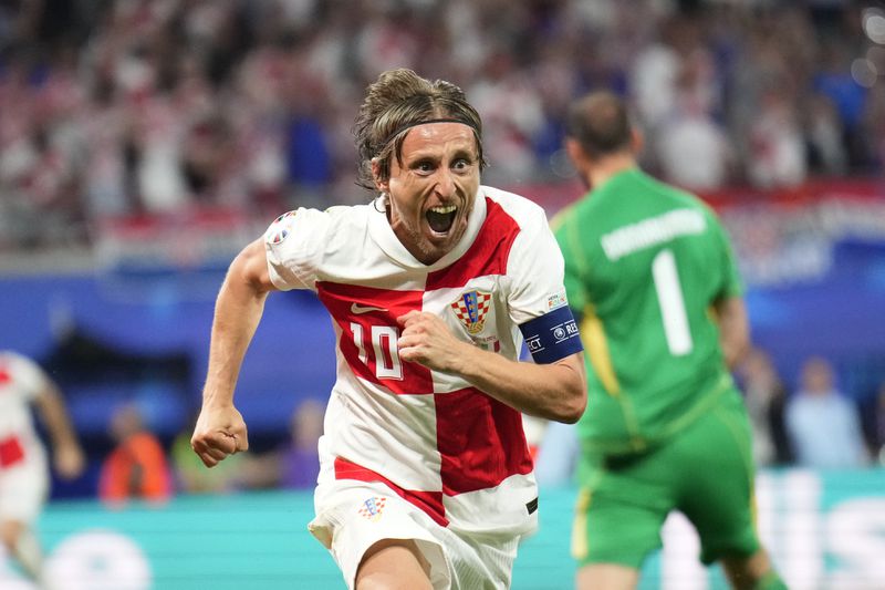 Croatia's Luka Modric celebrates after scoring his side's opening goal during a Group B match between Croatia and Italy at the Euro 2024 soccer tournament in Leipzig, Germany, Monday, June 24, 2024. (AP Photo/Ebrahim Noroozi)