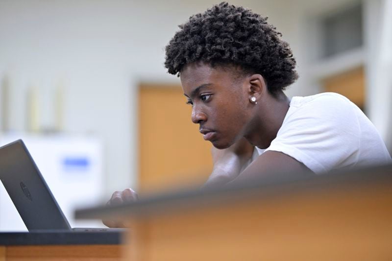 Flerentin “Flex” Jean-Baptiste, 16, of Medford, Mass., works on an assignment during summer school at Medford High School, Friday, Aug. 2, 2024, in Medford. (AP Photo/Josh Reynolds)