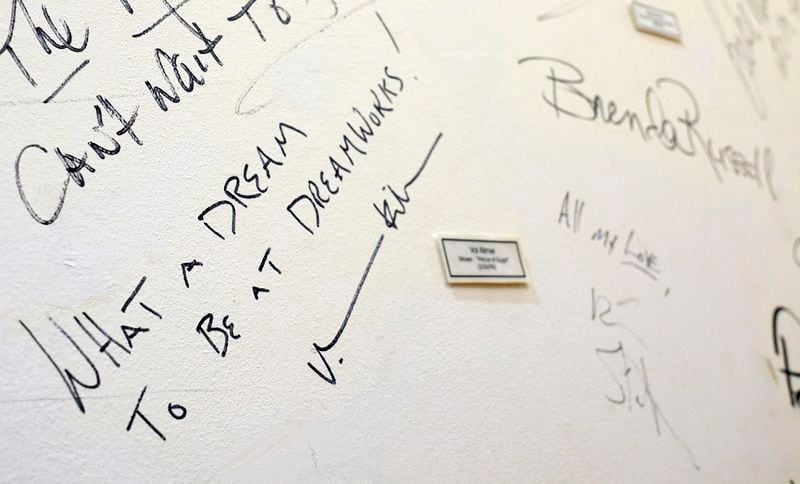 An inscription from Val Kilmer, a cast member in the 1998 DreamWorks animated film "The Prince of Egypt," is featured on a wall of signatures preserved from the original DreamWorks headquarters at Universal Studios, Wednesday, Sept. 25, 2024, at DreamWorks Animation in Glendale, Calif. (AP Photo/Chris Pizzello)