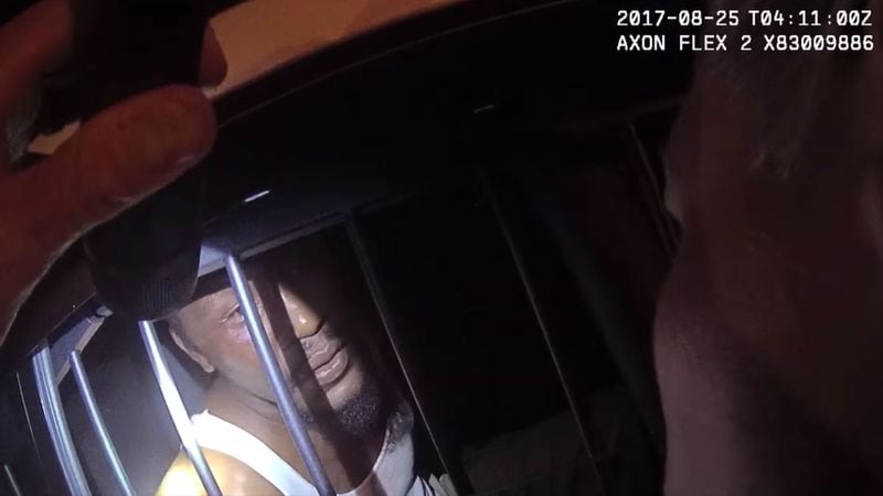 In a still image from body camera footage released Monday by Asheville, N.C., police officials, Johnnie Rush talks to Sgt. Lisa Taube the morning of Aug. 25, 2017, about pressing charges against Officer Christopher Hickman. Rush, 33, was walking home from work that morning when Hickman and his partner accused the Cracker Barrel employee of jaywalking. The subsequent confrontation, caught on camera and shared by a local newspaper in February, led to community outrage and a felony charge of assault by strangulation against Hickman, who resigned in January.