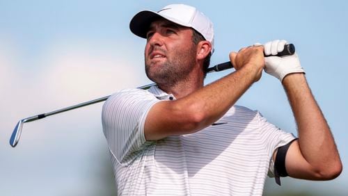 Scottie Scheffler hits his tee shot on the ninth hole during the third round of the Tour Championship golf tournament, Saturday, Aug. 31, 2024, in Atlanta. (AP Photo/Jason Allen)