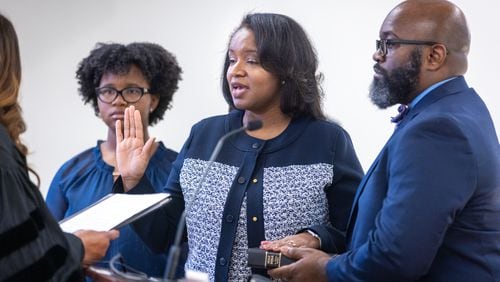 Gyimah Whitaker (center), surrounded by family, is sworn in as the new superintendent of the City Schools of Decatur on Tuesday, June 13, 2023. (Arvin Temkar / arvin.temkar@ajc.com)
