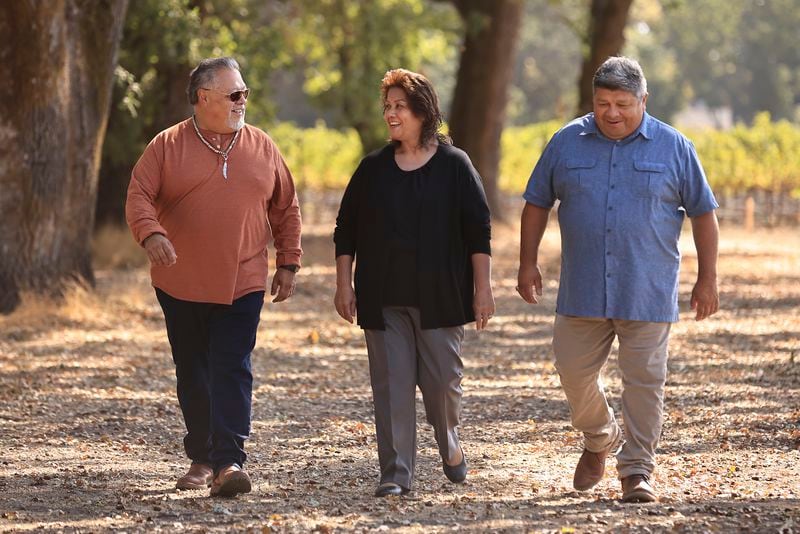 From left, Dino Beltran, Judy Fast Horse and Darin Beltran, of Sonoma County's Native American Koi Nation, tour a portion of land designated for casino project, Sept. 17, 2021, near Windsor, Calif. (Kent Porter/The Press Democrat via AP)