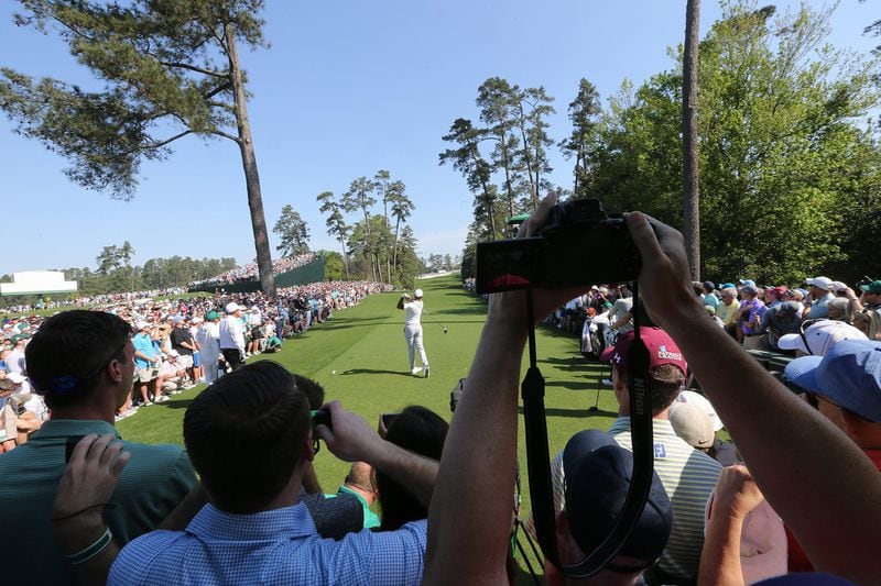 The crowd around the 18th tee watches Tiger Woods tee off during his practice round for the Masters at Augusta National Golf Club on April 3, 2018, in Augusta.