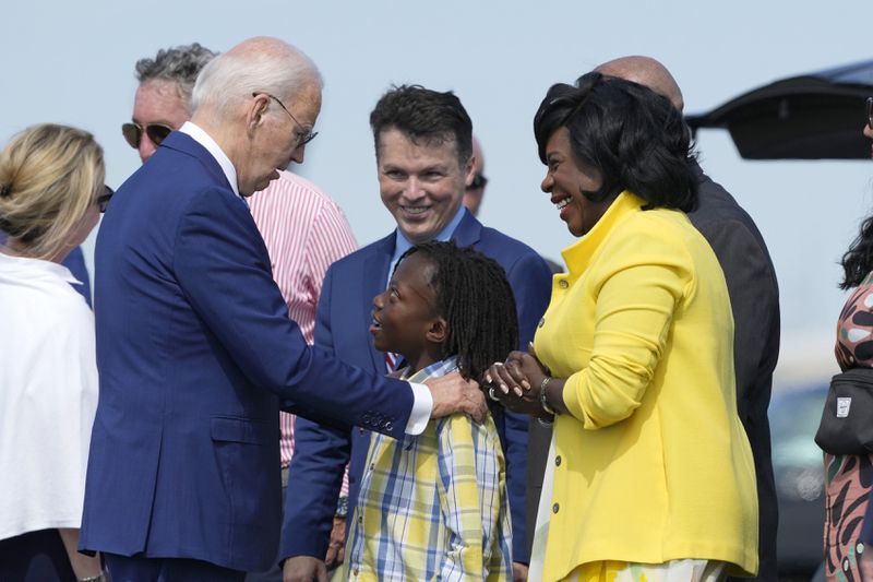 President Joe Biden, left, is greeted by Philadelphia Mayor Cherelle Parker, right, and her son Langston Mullins, center, as Rep. Brendan Boyle, D-Pa., looks on in background as Biden arrives at Philadelphia International Airport to participate in a campaign event in Philadelphia, Sunday, July 7, 2024. (AP Photo/Manuel Balce Ceneta)