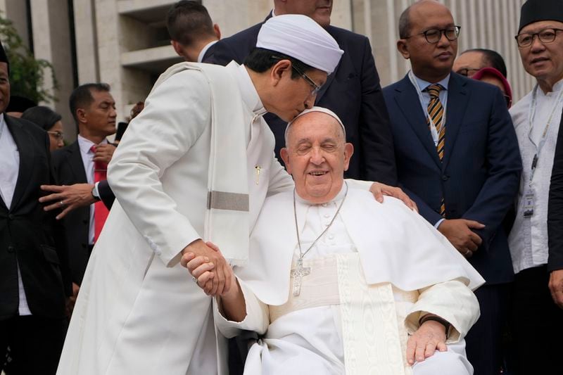 The Grand Imam Nasaruddin Umar, left, bids farewell to Pope Francis, as he leaves after signing the "Joint Declaration of Istiqlal 2024" at the Istiqlal Mosque in Jakarta, Thursday, Sept. 5, 2024. Pope Francis urged Indonesia to live up to its promise of "harmony in diversity" and fight religious intolerance on Wednesday, as he set a rigorous pace for an 11-day, four-nation trip through tropical Southeast Asia and Oceania. (AP Photo/Gregorio Borgia)