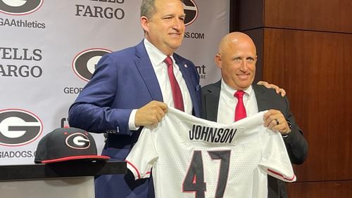 Georgia Athletic Director Josh Brooks (L) presents Wes Johnson with his baseball jersey after introducing Johnson as the Bulldogs' new baseball skipper. (Photo by Chip Towers/ctowers@ajc.com)