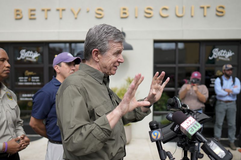 North Carolina governor Roy Cooper talks to the media on Thursday, Oct. 3, 2024, in Boone, N.C. in the aftermath of hurricane Helene. In the final weeks of the presidential election, people in North Carolina and Georgia, influential swing states, are dealing with more immediate concerns: recovering from Hurricane Helene. (AP Photo/Chris Carlson)