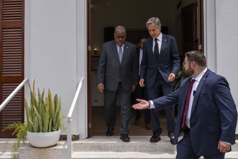 U.S. Secretary of State Antony Blinken, top right, and Haitian Prime Minister Garry Conille arrive to speak to the press at the U.S. Chief of Mission Residence in Port-au-Prince, Haiti, Thursday, Sept. 5, 2024. (Roberto Schmidt/Pool photo via AP)