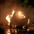 A vehicle is seen on fire at the site of an explosion that caused injures and destroyed vehicles at outside the Karachi airport, Pakistan, Sunday, Oct. 6, 2024. (AP Photo/Mohammad Farooq)