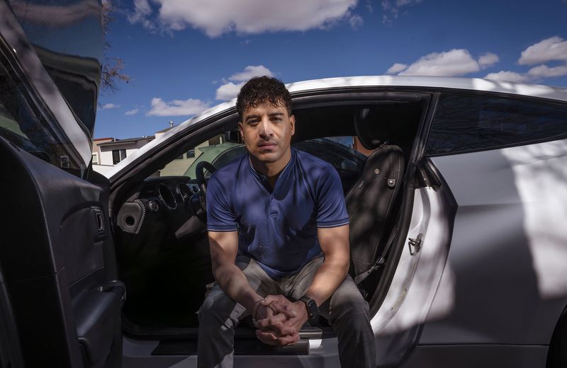 Carlos Sandoval-Smith, who detailed his encounters with an Albuquerque police officer and a law firm implicated in a DWI corruption probe, poses in Albuquerque, N.M., Thursday, Feb. 23, 2024. (Chancey Bush/The Albuquerque Journal via AP)