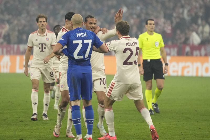 Bayern's Leroy Sane, second right celebrates with teammates after scoring his sides 8th goal, during the Champions League opening phase soccer match between Bayern Munich and GNK Dinamo at the Allianz Arena in Munich, Germany Tuesday, Sept. 17, 2024. (AP Photo/Matthias Schrader)