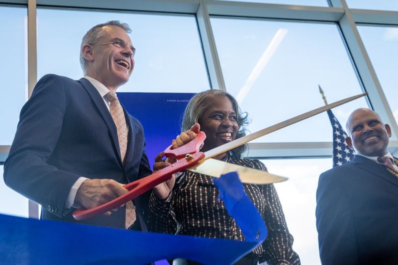 (L-R) Ambassador of Denmark to the United States Jesper Moller Sorensen, Atlanta Interim Chief Operating Officer LaChandra Burks, and Hartsfield-Jackson Airport General Manager Balram Bheodari cut a ribbon at an inaugural flight event for Scandinavian Airlines to Copenhagen at Hartsfield-Jackson airport in Atlanta on Monday, June 17, 2024. The airline will provide a new route of daily nonstop flights between Atlanta and Copenhagen. (Arvin Temkar / AJC)