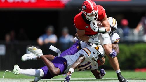 Georgia tight end Oscar Delp (4) makes a first down catch against Tennessee Tech defensive back Omari Philyaw (16) during the first half at Sanford Stadium, Saturday, Sept. 7, 2024, in Athens, Ga. Georgia won 48-3. (Jason Getz / AJC)
