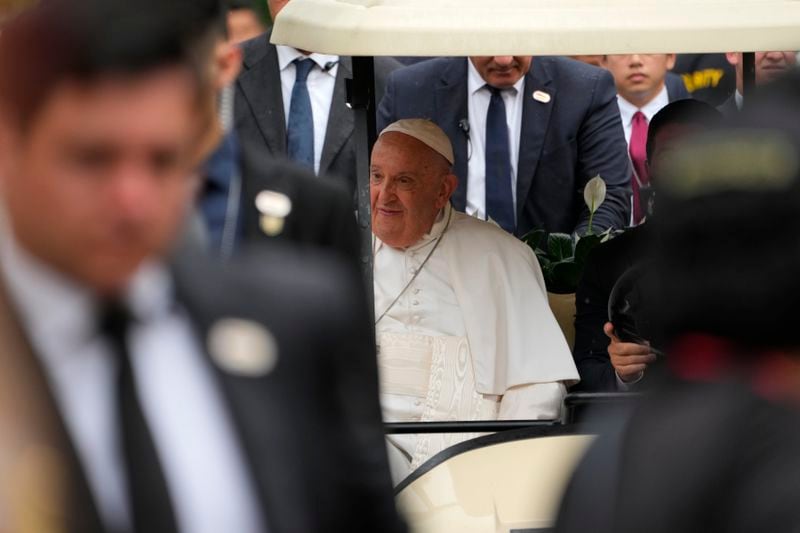 Pope Francis travels in a buggy after he arrived in Singapore, Wednesday, Sept. 11, 2024. (AP Photo/Vincent Thian)