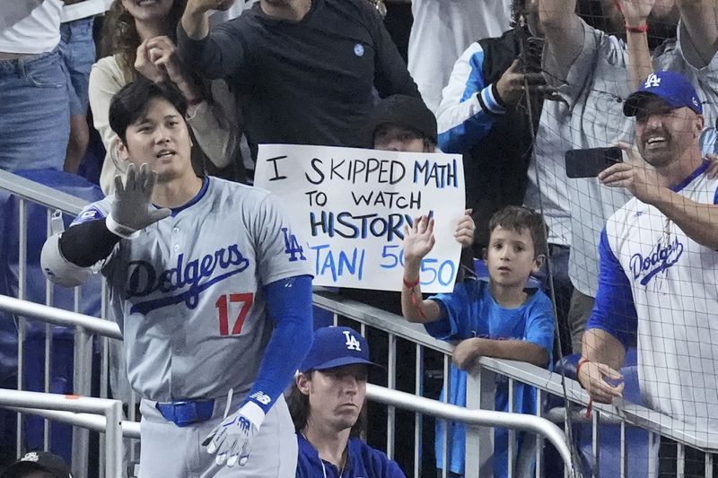 Los Angeles Dodgers' Shohei Ohtani (17) waves to fans after he hit a home run scoring Andy Pages, during the seventh inning of a baseball game against the Miami Marlins, Thursday, Sept. 19, 2024, in Miami. (AP Photo/Wilfredo Lee)