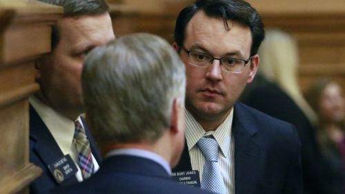 Sen. Burt Jones confers with colleagues on the floor. BOB ANDRES / BANDRES@AJC.COM