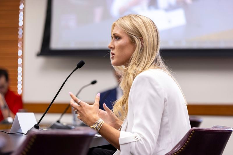 Former collegiate swimmer Riley Gaines, who competed in Georgia but isn't from the state, testifies in opposition to transgender athletes in women's sports in front of the state senate's Special Committee on Protecting Women's Sports at the Capitol in Atlanta, Tuesday, Aug. 27, 2024. (Arvin Temkar/Atlanta Journal-Constitution via AP)