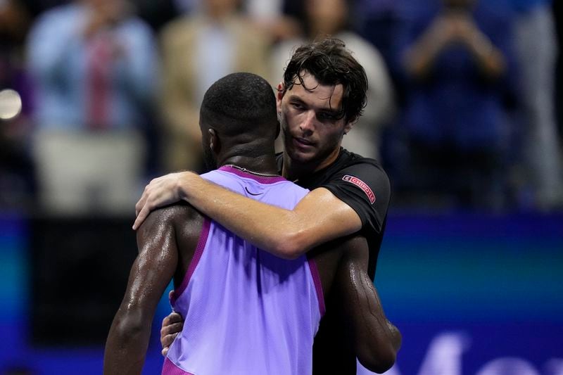 Taylor Fritz, of the United States, hugs Frances Tiafoe, of the United States, after winning the men's singles semifinals of the U.S. Open tennis championships, Friday, Sept. 6, 2024, in New York. (AP Photo/Kirsty Wigglesworth)