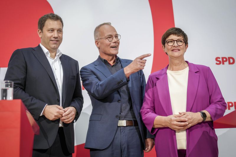 Saskia Esken, right, SPD Federal Chairwoman, and Lars Klingbeil, left, SPD Federal Chairman, introduce Matthias Miersch as the new SPD General Secretary during a press conference at the party's headquarters in Berlin, Germany, Tuesday Oct. 8, 2024. (Kay Nietfeld/dpa via AP)