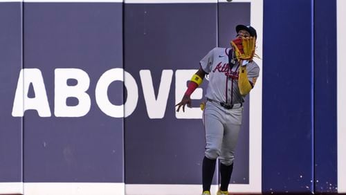 Atlanta Braves right fielder Ronald Acuna Jr. catches a ball hit by Miami Marlins' Vidal Brujan during the fifth inning of a baseball game, Saturday, April 13, 2024, in Miami. (AP Photo/Wilfredo Lee)