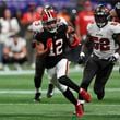 Atlanta Falcons wide receiver KhaDarel Hodge (12) outrusn Tampa Bay Buccaneers linebacker K.J. Britt (52) to the endzone to score the game-winning touchdown against the Tampa Bay Buccaneers during overtime in an NFL football game Friday, Oct. 4, 2024, in Atlanta. (AP Photo/John Bazemore)