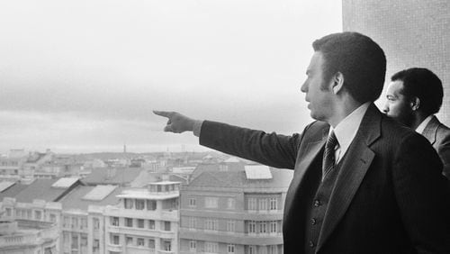 Andrew Young, left, U.S. ambassador to the United Nations, and his aide, Stoney Cooks, right, look over the skyline of Lisbon, Sunday, May 15, 1977, from vantage point on the roof of a city hotel. (AP Photo)
