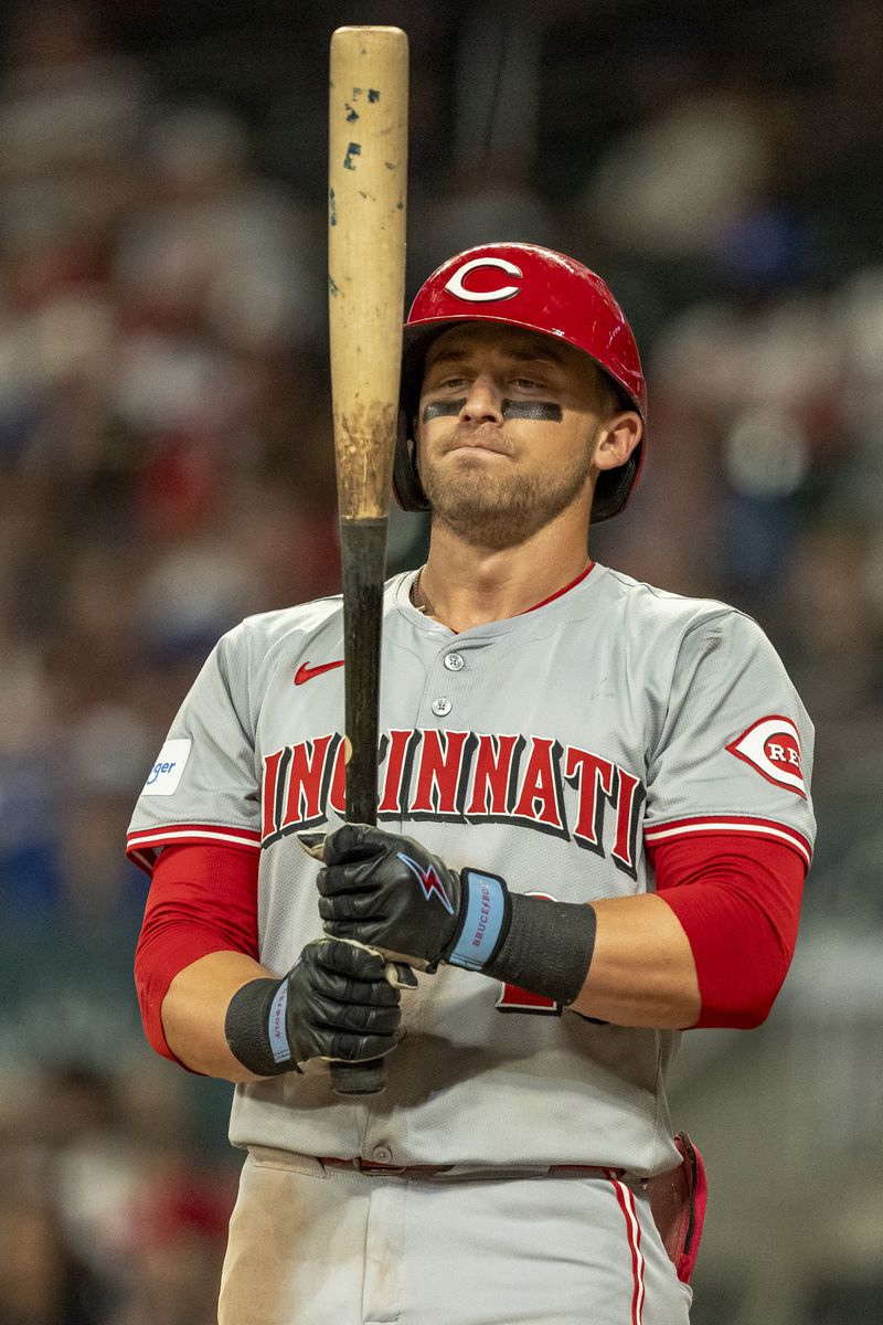 Cincinnati Reds' TJ Friedl checks his bat before he stands in the batter's box in the eighth inning of a make-up baseball game against the Atlanta Braves, Monday, Sept. 9, 2024, in Atlanta. (AP Photo/Jason Allen)