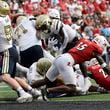 Georgia Tech running back Jamal Haynes, center, leaps over the line to score during the first half of an NCAA college football game in Louisville, Ky., Saturday, Sept. 21, 2024. (AP Photo/Timothy D. Easley)