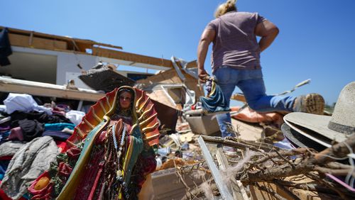 A Guadalupe Virgin statue is seen in the destroyed home of Juana Landeros, who rode out deadly tornado with her husband and her 9-year-old son when it rolled through the previous night, Sunday, May 26, 2024, in Valley View, Texas. Powerful storms left a wide trail of destruction Sunday across Texas, Oklahoma and Arkansas after obliterating homes and destroying a truck stop where drivers took shelter during the latest deadly weather to strike the central U.S. (AP Photo/Julio Cortez)
