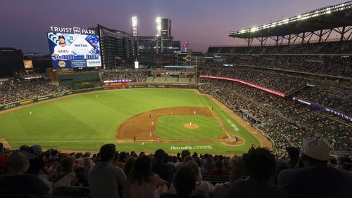 General view as the sun sets during the top of the sixth inning as the Atlanta Braves play defense against the San Francisco Giants at Truist Park, Tuesday, July 2, 2024, in Atlanta. (Jason Getz / AJC)
