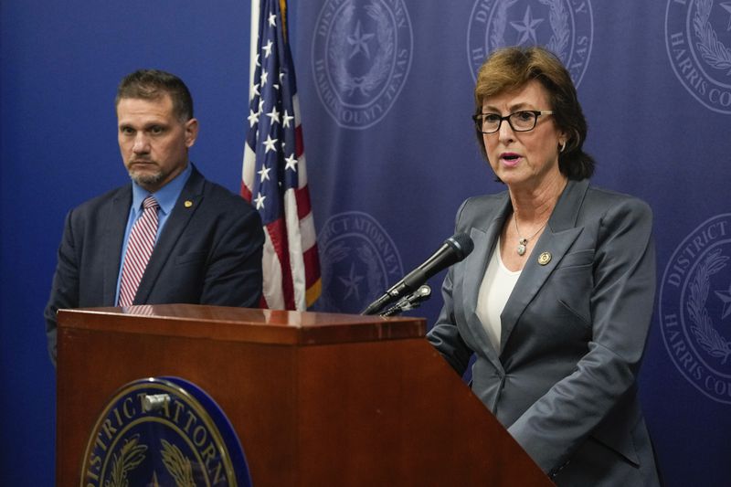 Harris County District Attorney Kim Ogg announces corruption charges related to 2022 Election alongside Michael Levine, Chief Assistant District Attorney for Public Corruption, during a press conference Tuesday, Aug. 13, 2024, in Houston. Prosecutors say an investigation found no evidence of intent to influence 2022 election outcomes, but Ogg said that her office will pursue criminal charges against a county employee who was allegedly working a second job while polls ran out of paper ballots. (Raquel Natalicchio/Houston Chronicle via AP)