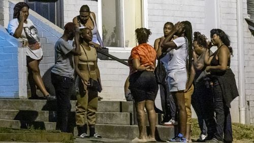 Family and friends gathered near the spot where two teenagers were killed in a shooting outside a southwest Atlanta apartment complex shortly after midnight on July 2.