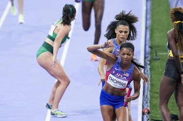 Sydney McLaughlin-Levrone hands off to Gabrielle Thomas, of the United States, during the women's 4 x 400-meter relay final at the 2024 Summer Olympics, Saturday, Aug. 10, 2024, in Saint-Denis, France. (AP Photo/Martin Meissner)