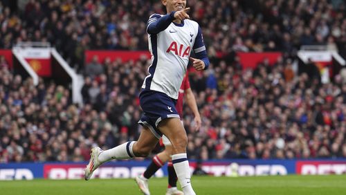 Tottenham's Brennan Johnson celebrates after scoring his side's opening goal during the English Premier League soccer match between Manchester United and Tottenham Hotspur at Old Trafford stadium in Manchester, England, Sunday, Sept. 29, 2024: (Martin Rickett/PA via AP)