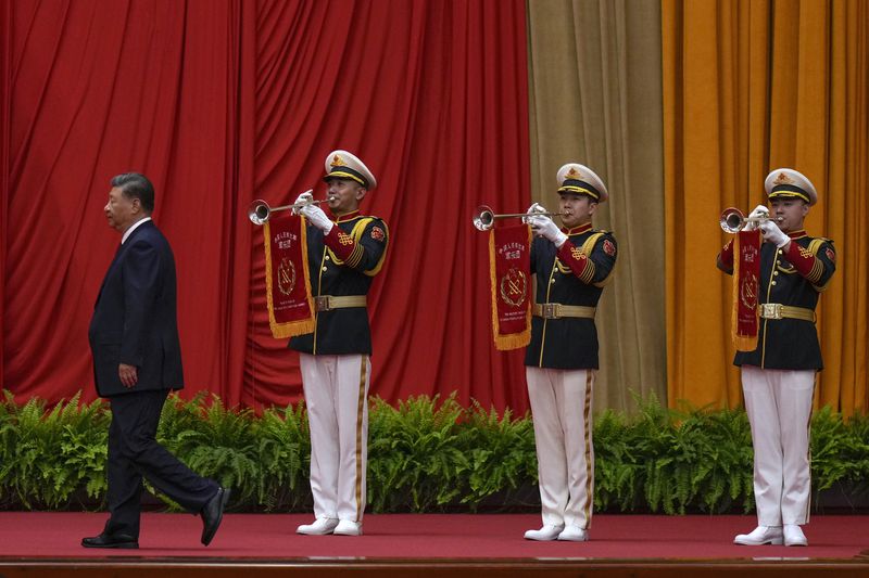 Chinese President Xi Jinping walks past a music band as he is on his way to deliver his speech at a dinner marking the 75th anniversary of the founding of the People's Republic of China, at the Great Hall of the People in Beijing, Monday, Sept. 30, 2024. (AP Photo/Andy Wong)